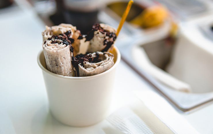 Rolled ice cream with chocolate topping.