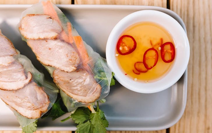 Assorted Vietnamese food sitting on a tray.