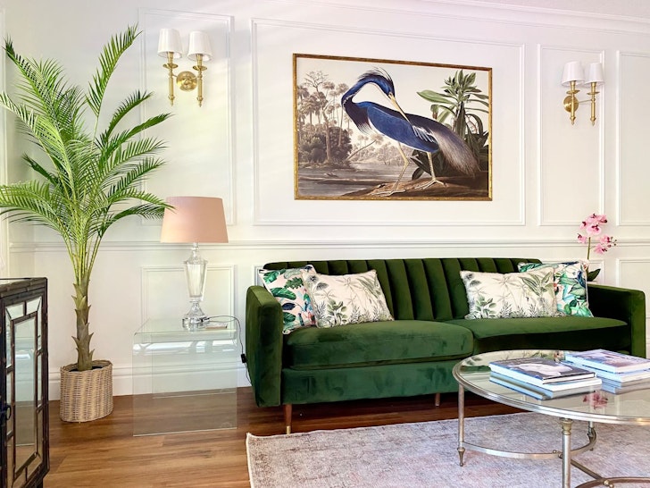A view of the green velvet lounge in the living space at Ultima one of the best Port Douglas Airbnbs