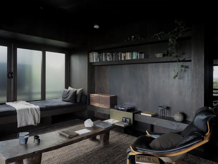 A moodily lit living room at Shack Palace Airbnb In Noosa
