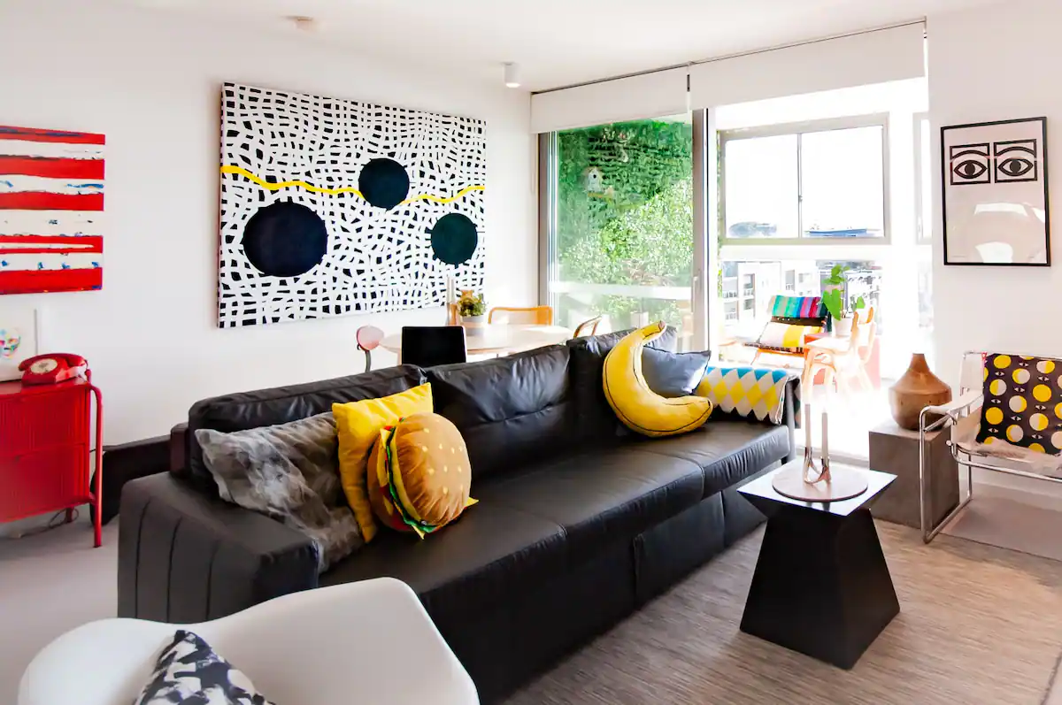 Colourful living room with contemporary art and funky cushions
