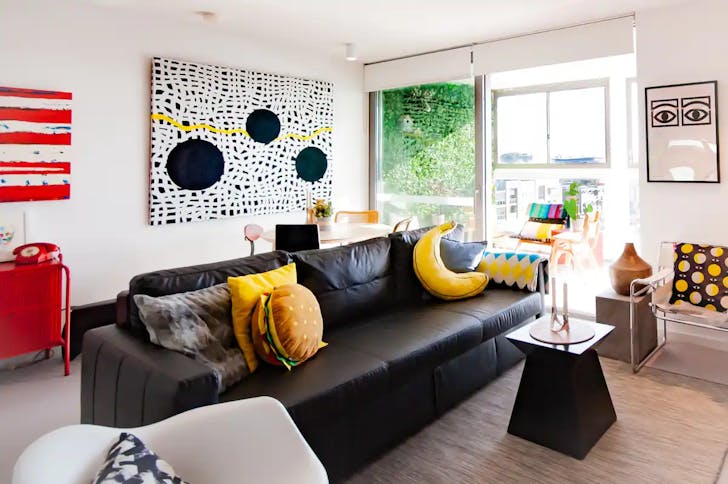 Colourful living room with contemporary art and funky cushions