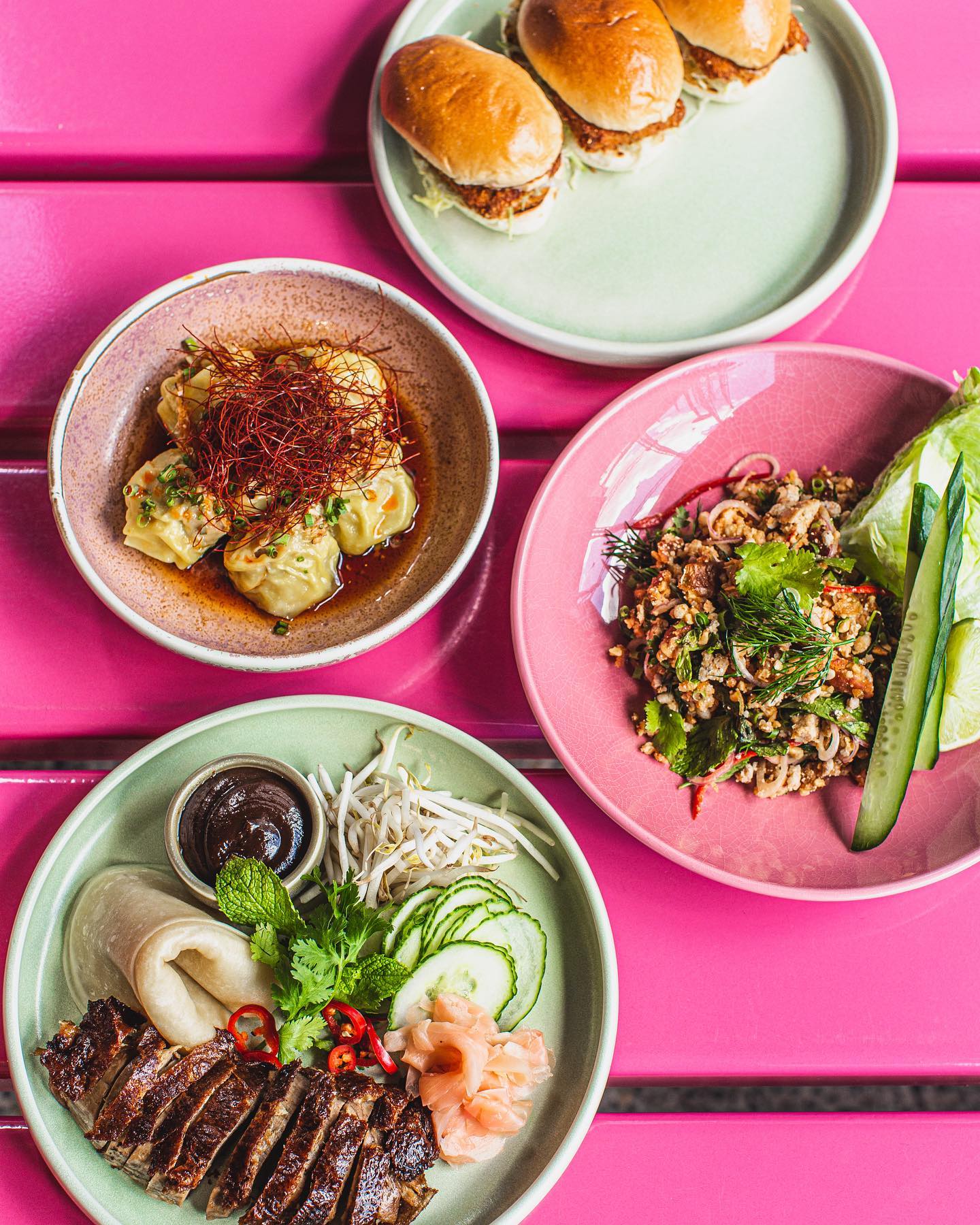 thai dishes on a pink table