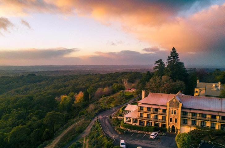 An aerial view of the historic-looking Mount Lofty House one of the best Adelaide Hills accommodation options