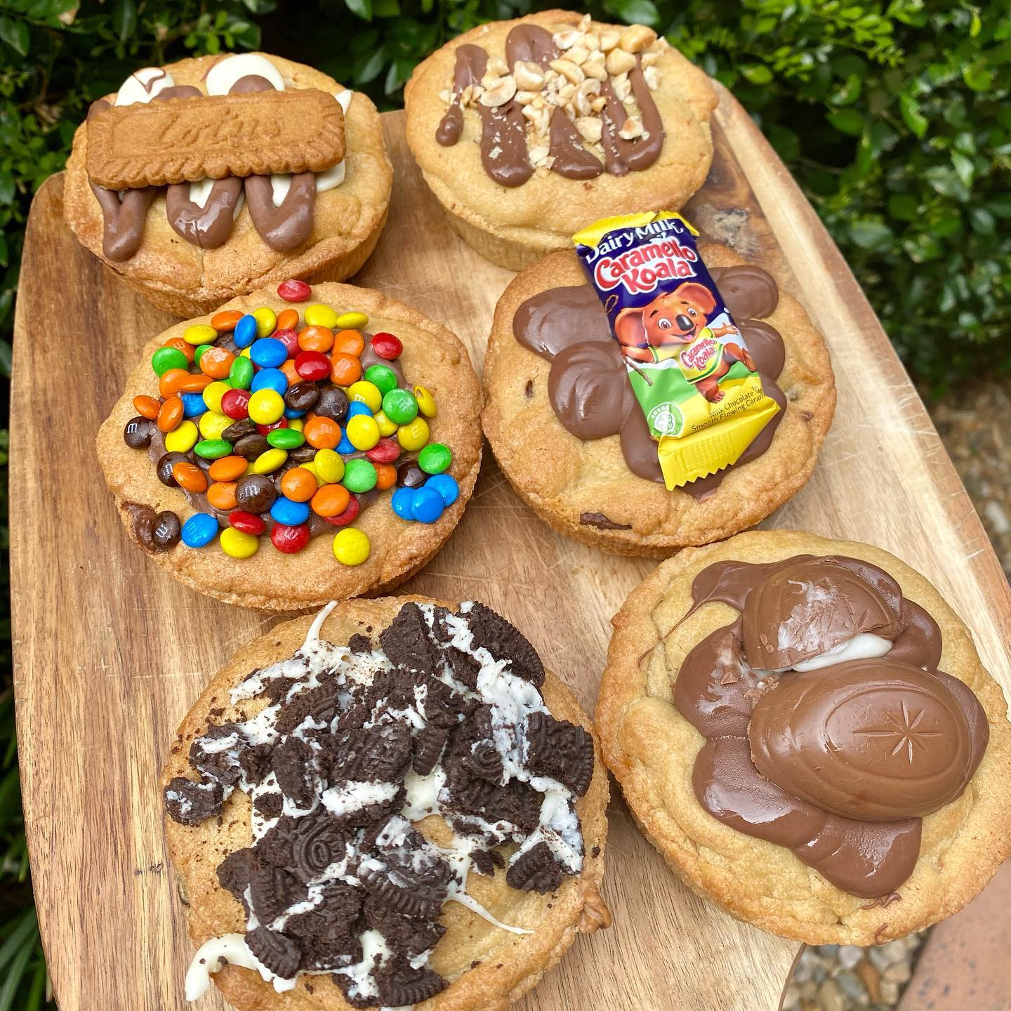 a wooden board piled with cookie pies