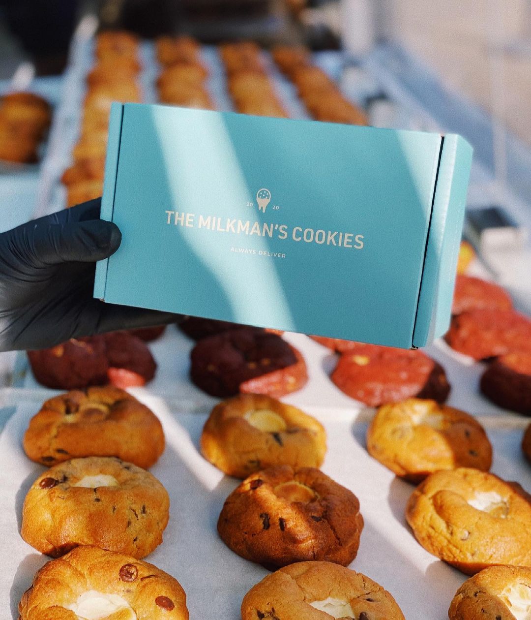 a turquoise box against a backdrop of cookies