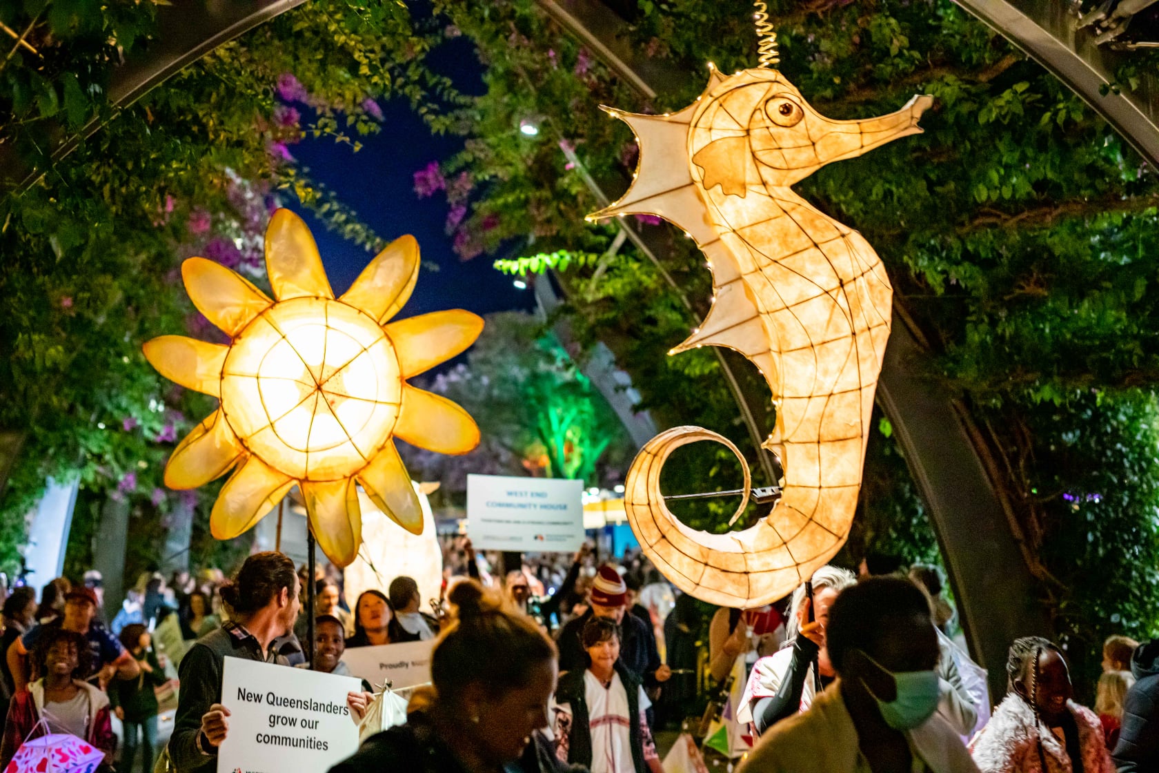 a parade at night with animals lanterns