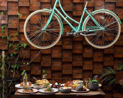 Image of blue bicycle hanging up at 1982 Food + Coffee
