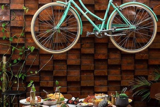 Image of blue bicycle hanging up at 1982 Food + Coffee