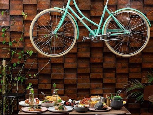 Image of blue bicycle hanging up at 1982 Food + Coffee