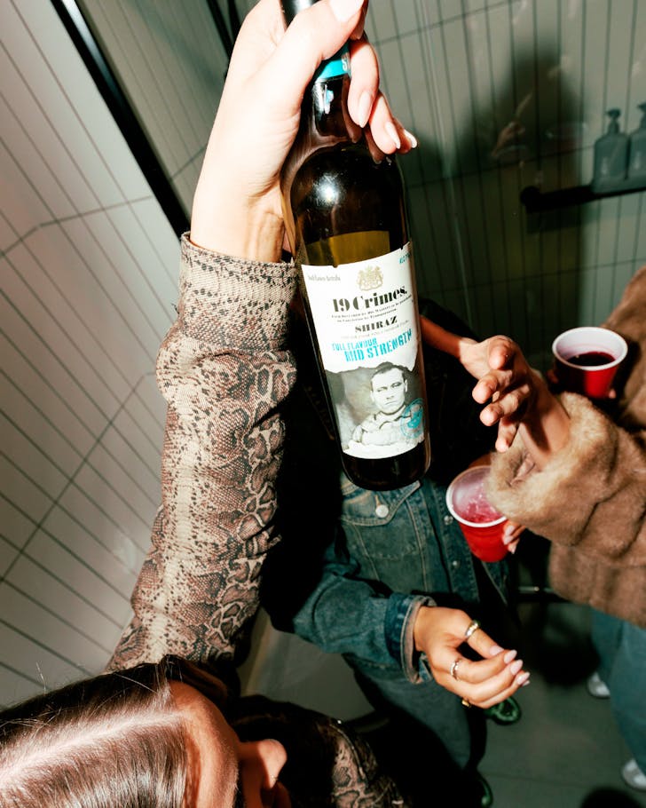 19 crimes bottles of wine head above a girl partying