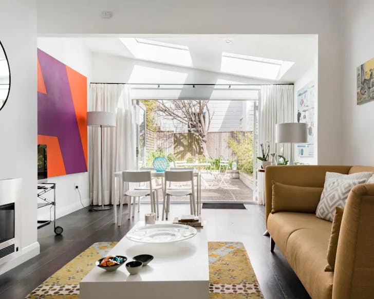 The living space at the renovated 19th-Century Cottage is airy and open with an adjoining outdoor area