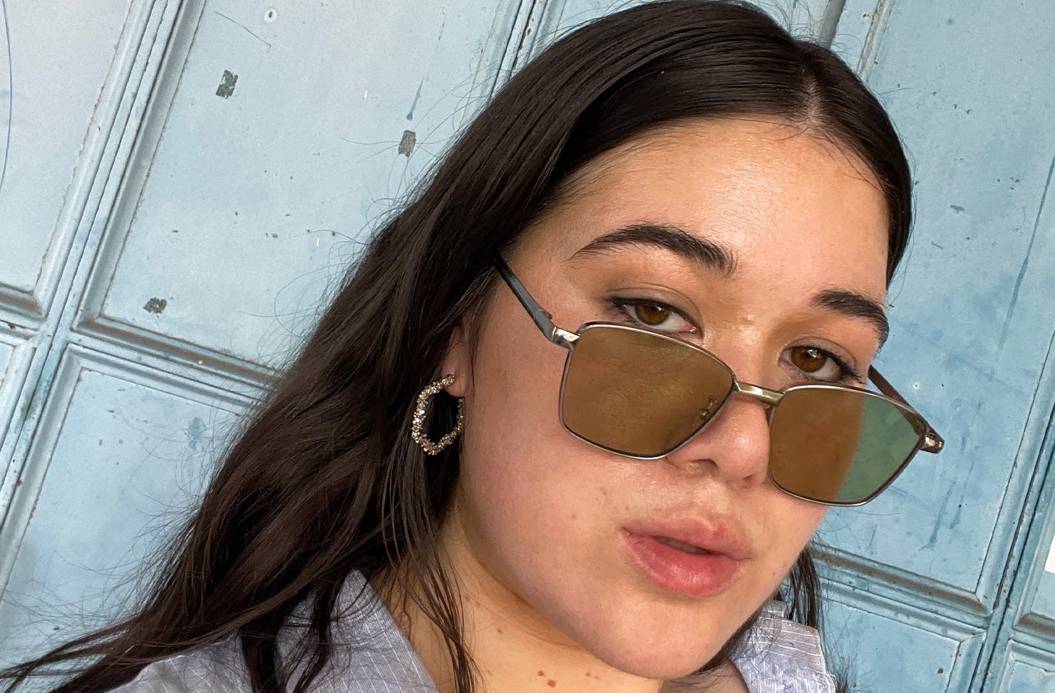Woman with sunglasses on and anti-dandruff hair. 