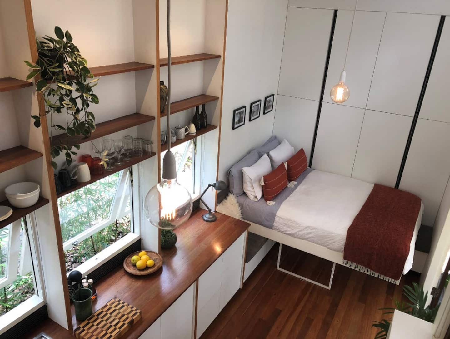 a bed and shelves inside a tiny house