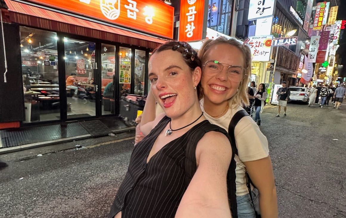 Two people taking selfie in street