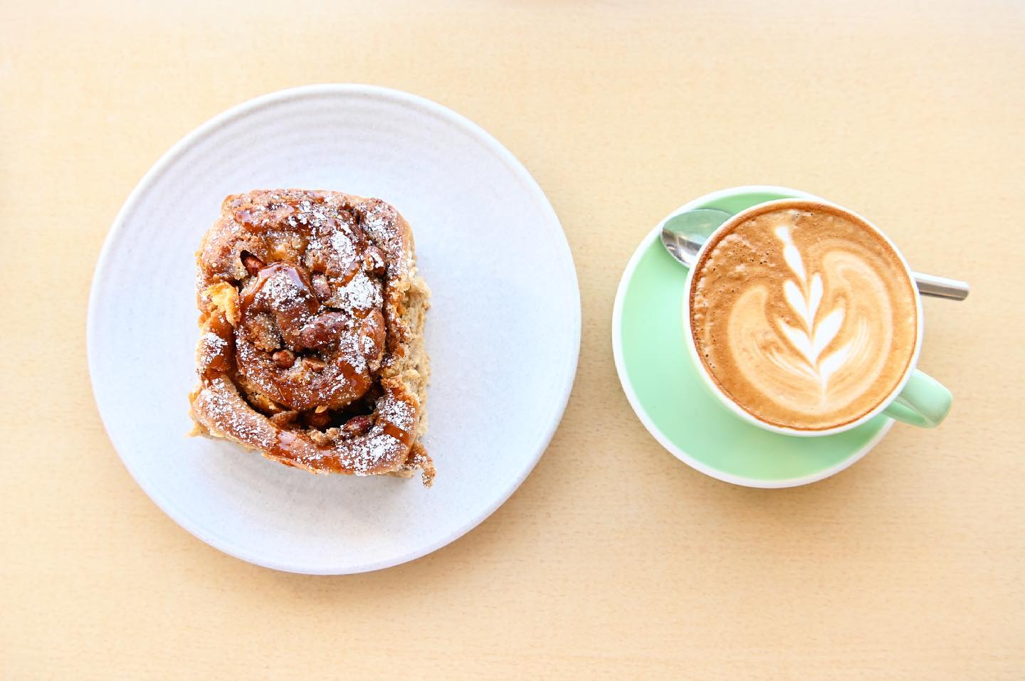 a cinnamon scroll and a latte