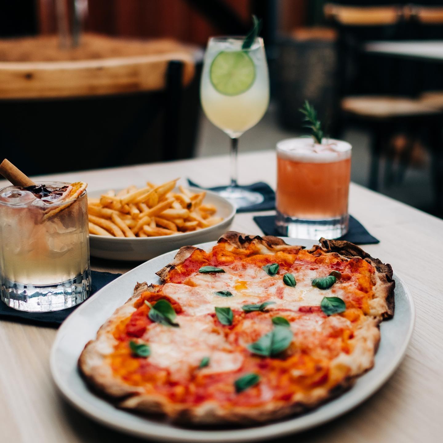 pizzas and cocktails on a table
