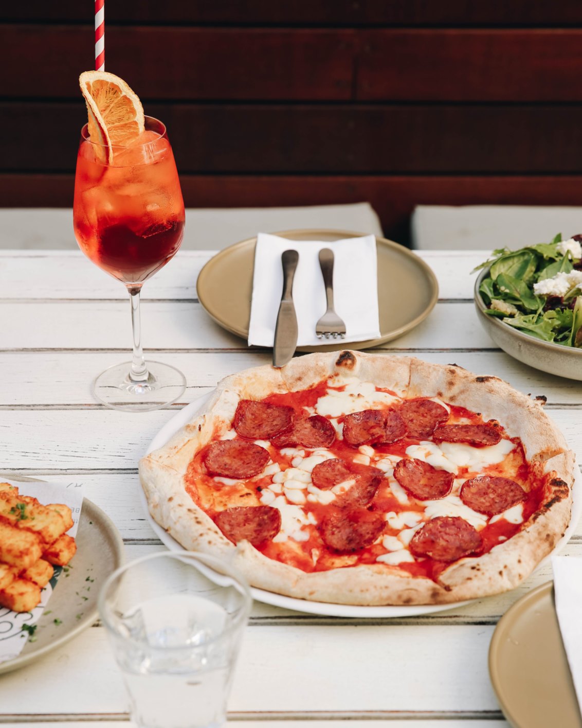 a pizza and a cocktail on a table