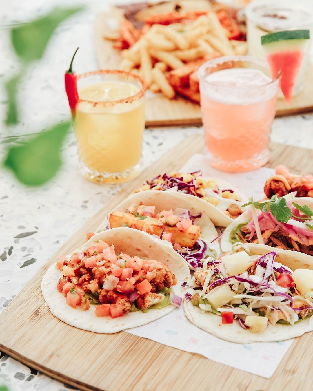 a plate of tacos and a cocktail