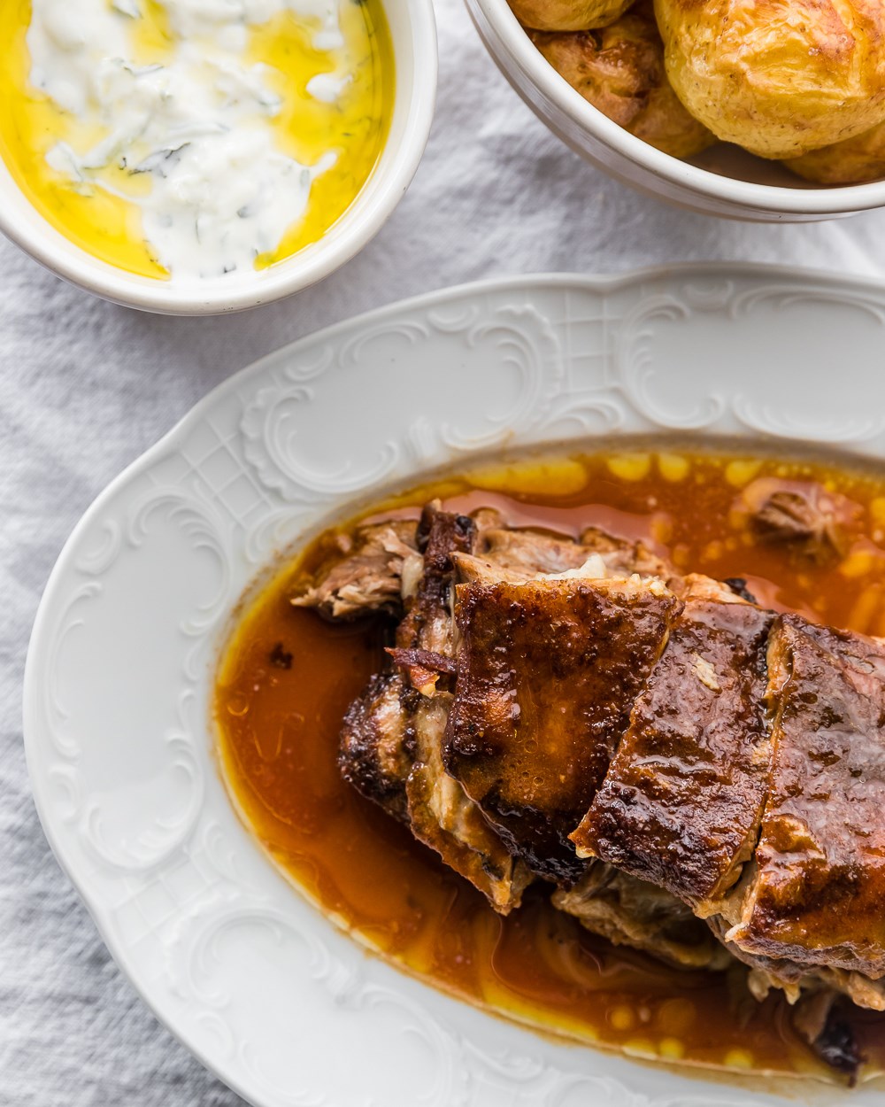 a plate of lamb shoulder with potatoes and yoghurt