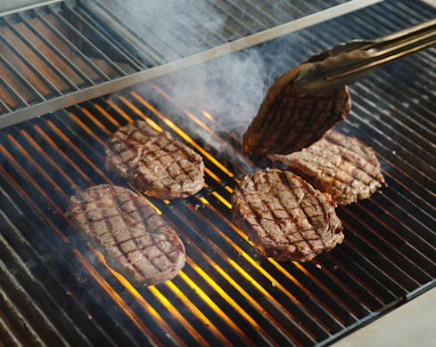 steaks being grilled at 24 york sydney cbd steak restaurant