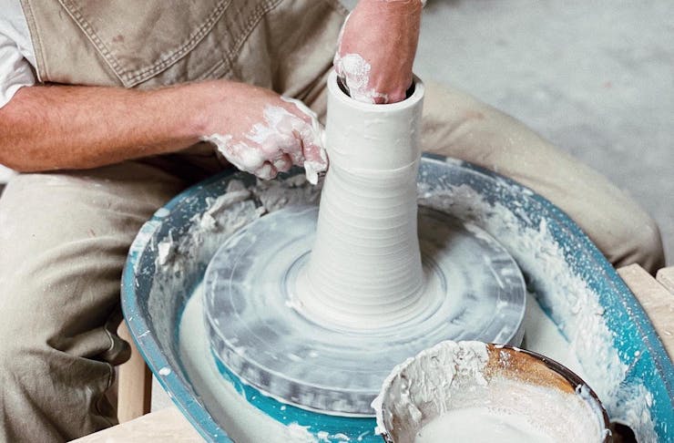 Someone turning a ceramic creation at Mas & Miek Ceramic House Brisbane workshop