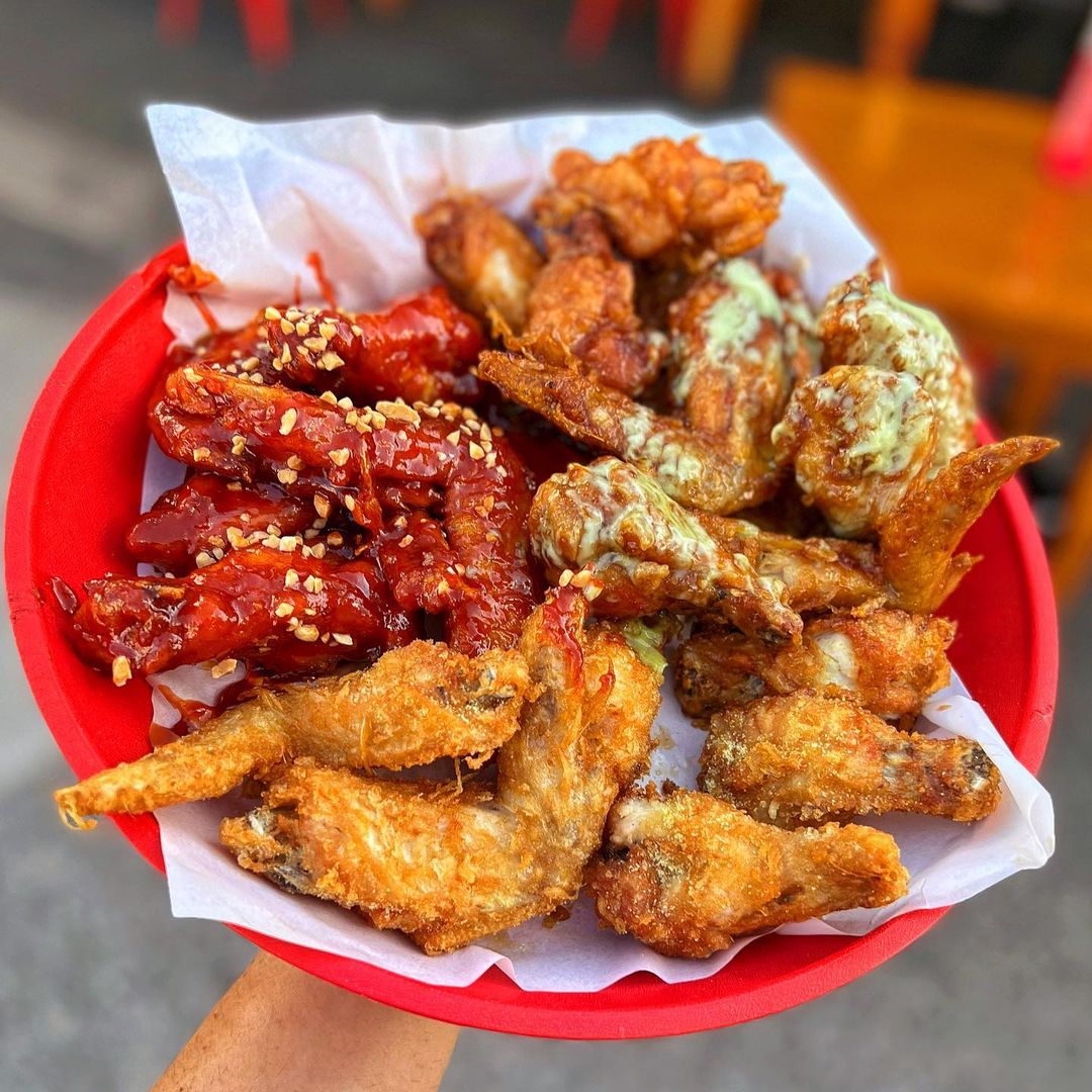 a basket of different flavoured chicken wings