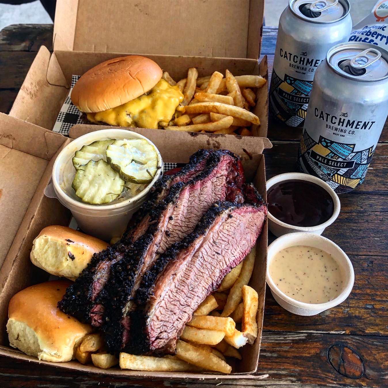 a takeaway box of brisket, fries and pickles