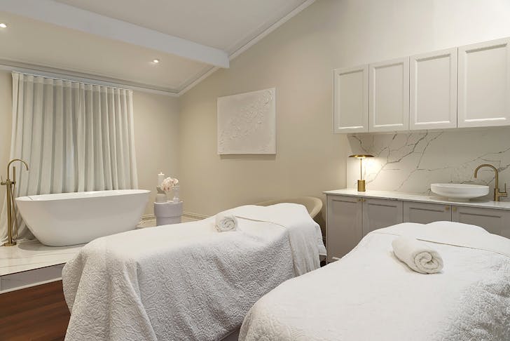 Treatment room with a bath at olive and july south perth