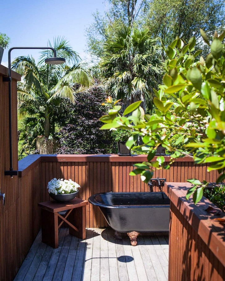 A view of the outdoor bath at Waihi Beach Chalet one of the best NZ Airbnbs