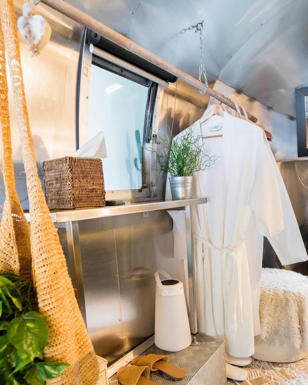 The interior of an Airstream with a robe hanging.