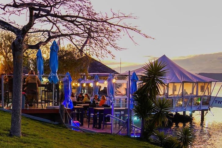 The exterior of 2 mile Taupo is lit up while people dine. One of the best restaurants in Taupo.