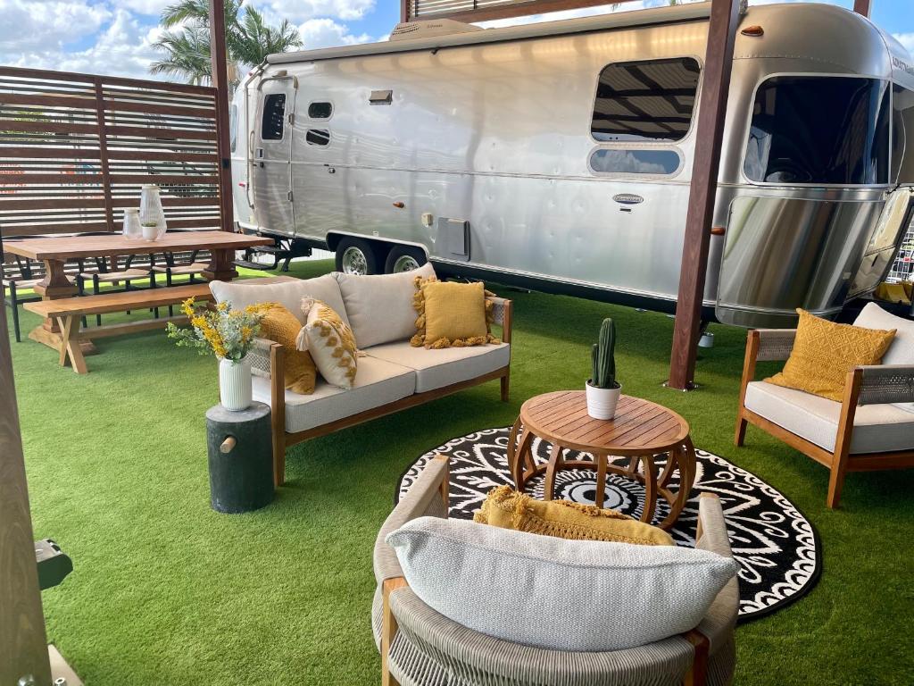 a silver caravan with a astro turf seating area outside