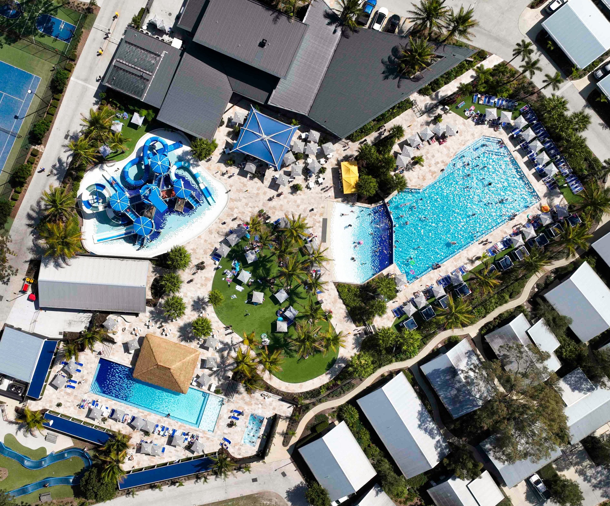 a drone view of a resort with pools