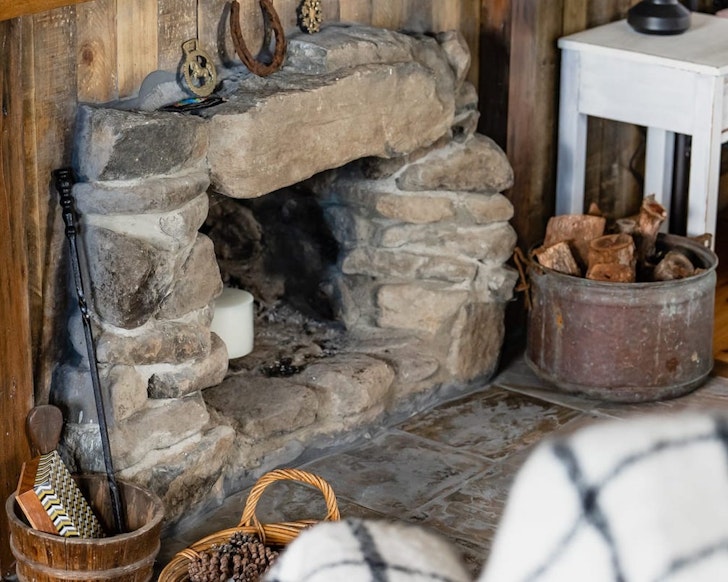 The stone fireplace at Carreg Cottage