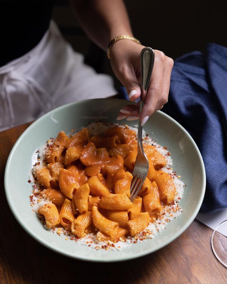 enjoying a plate of pasta at matteo downtown's bottomless brunch