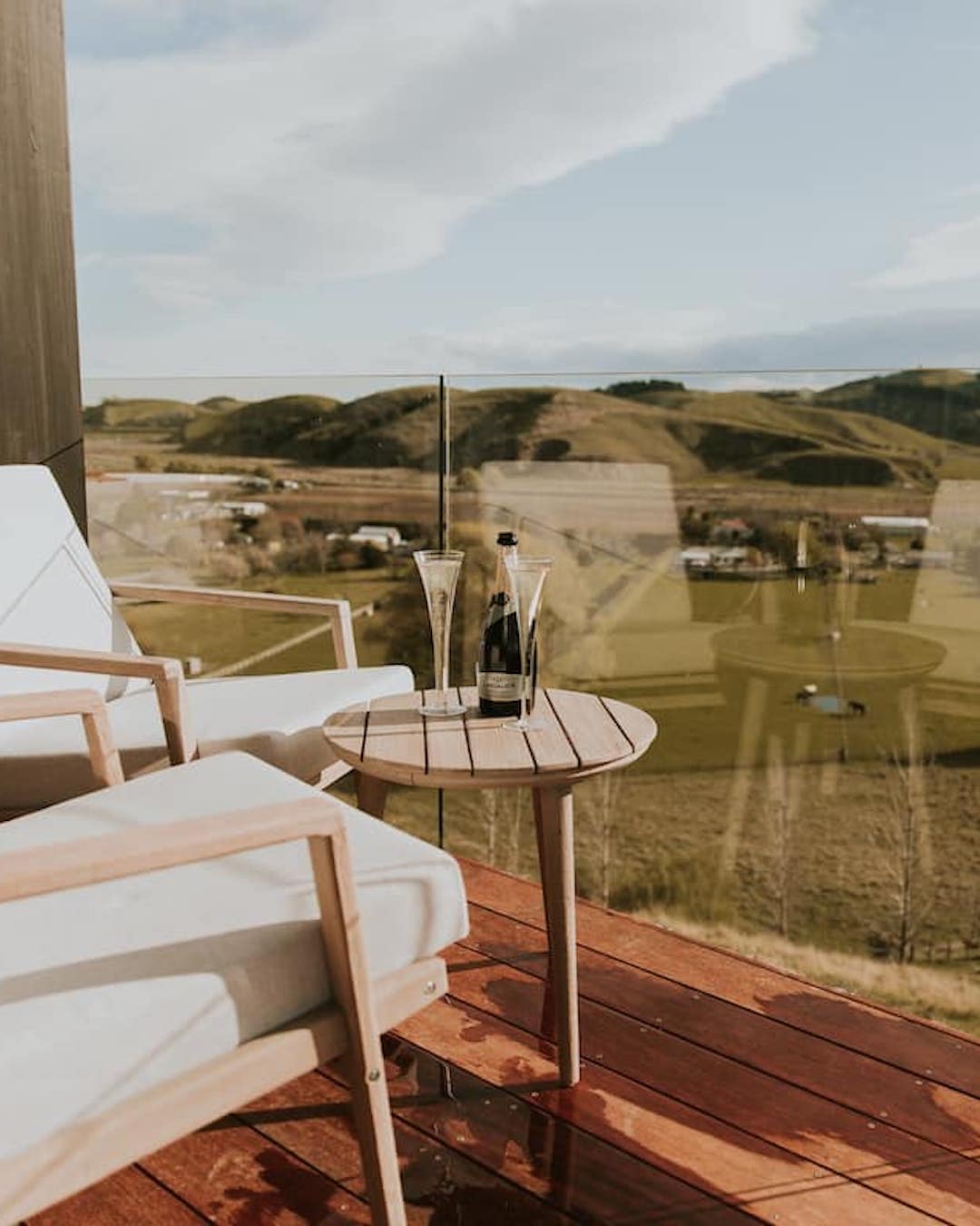 An Airbnb with an outdoor setting with champagne overlooking farmland