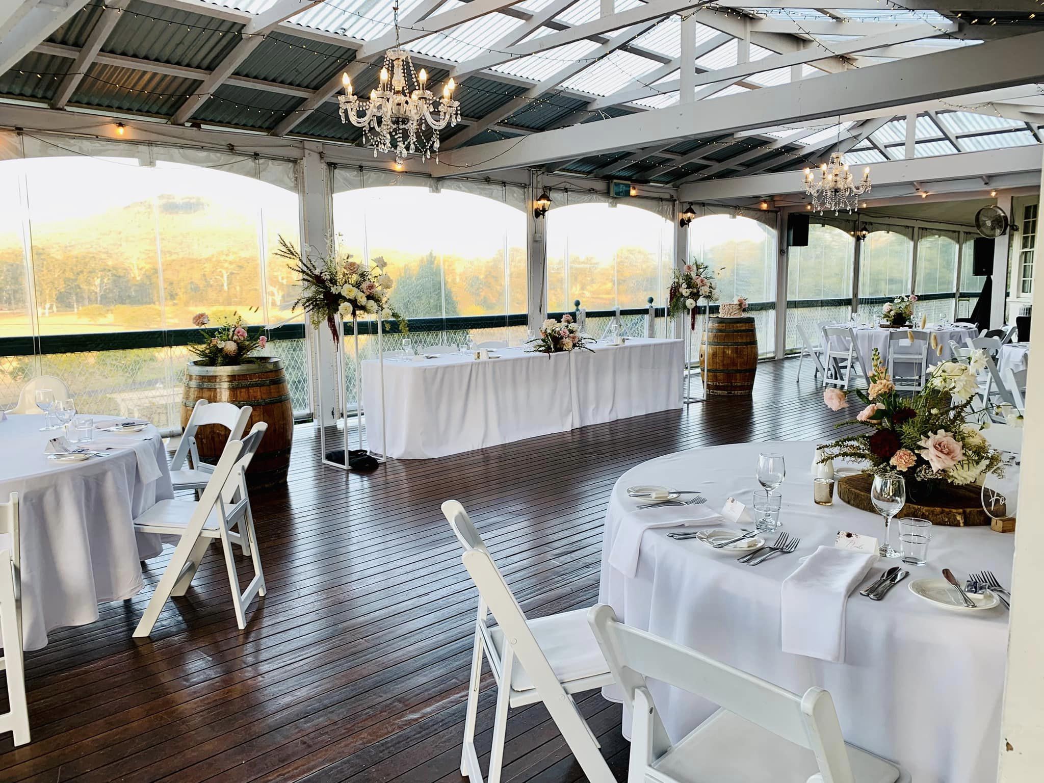 wedding tables on a verandah overlooking a vineyard at a wedding venue near brisbane