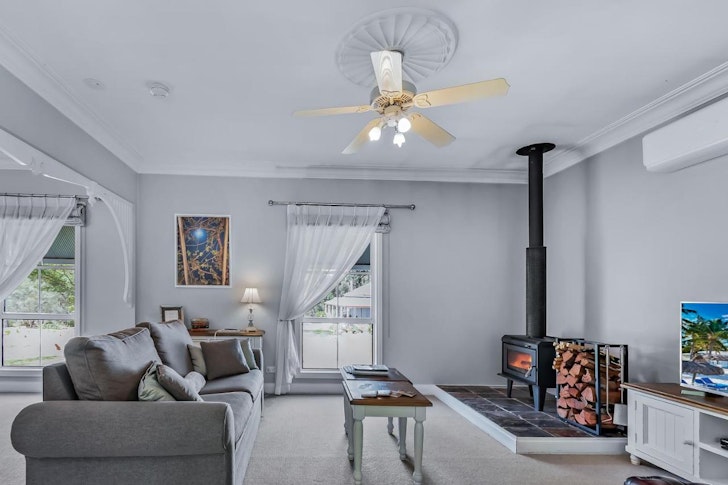 A view of the living room and fireplace at Diamondvale Cottages