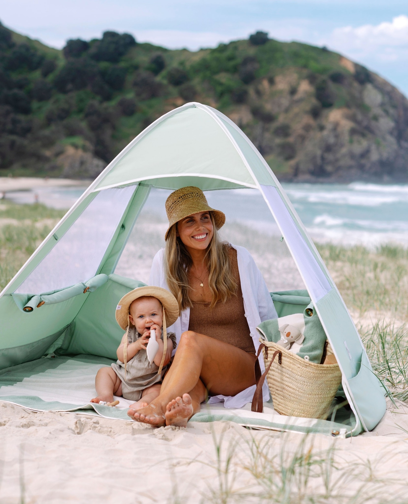 a baby shower gift idea of a pop up beach tent in sage green