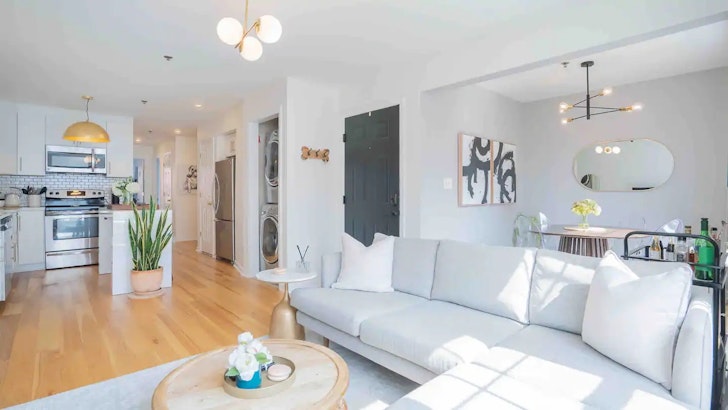 Couch near kitchen in white house