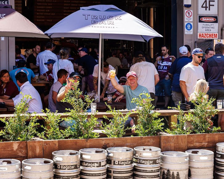 People sit outside the 4 Pines Brewery Truck bar, where you can watch the FIFA womens world cup