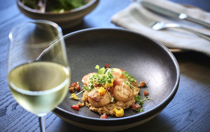 a bowl of food with a glass of wine at samuels on mill  
