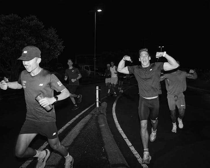 A balck and white photo of the 445 Run Club hitting the pavement.