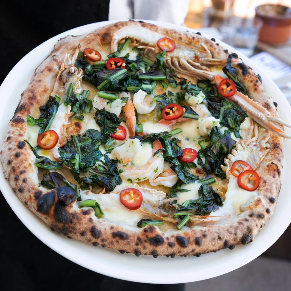 A pizza with prawns and chilli at an Italian restaurant Melbourne. 