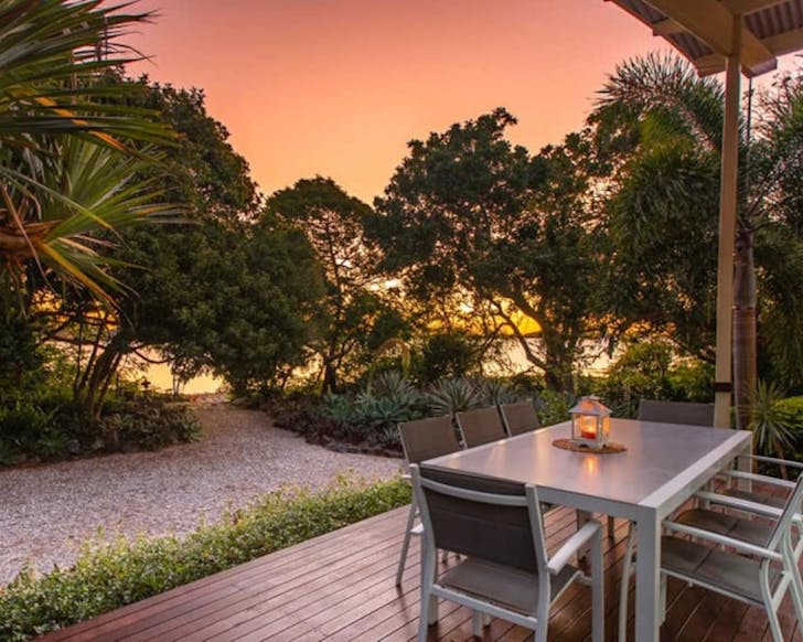 A deck on Victor Island overlooking the ocean at sunset.