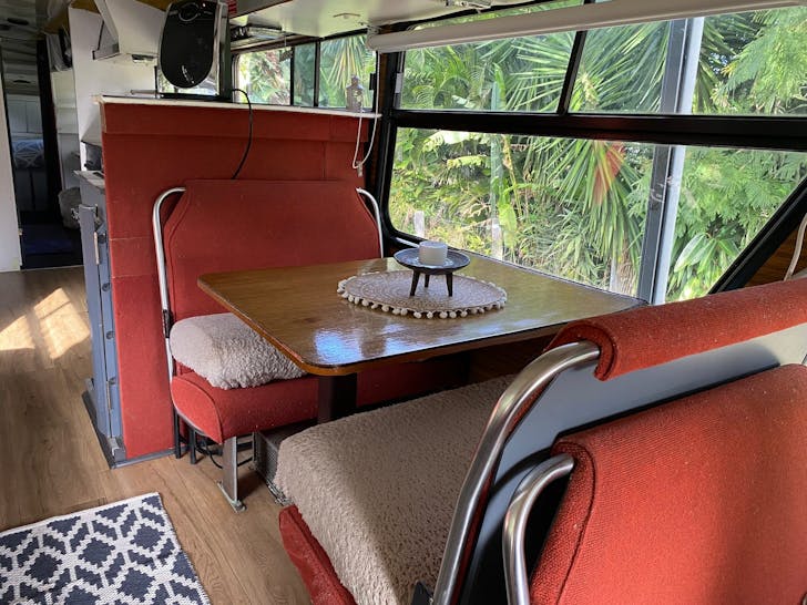 bus seats with a table in the middle on a bus
