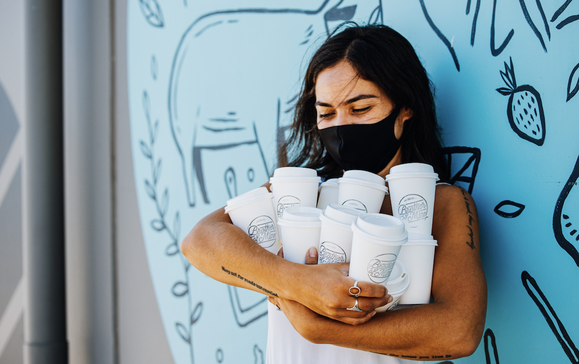 person holding bags of coffee