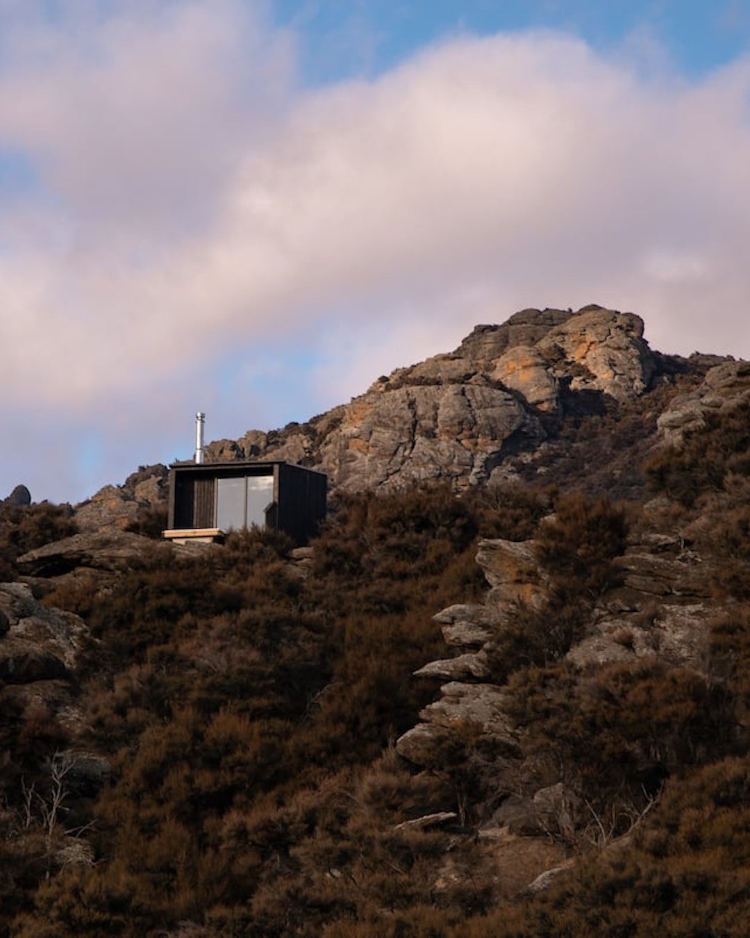 A stunning cabin perched amongst rocks.