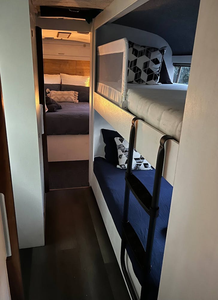 a bedroom and bunk beds in a bus
